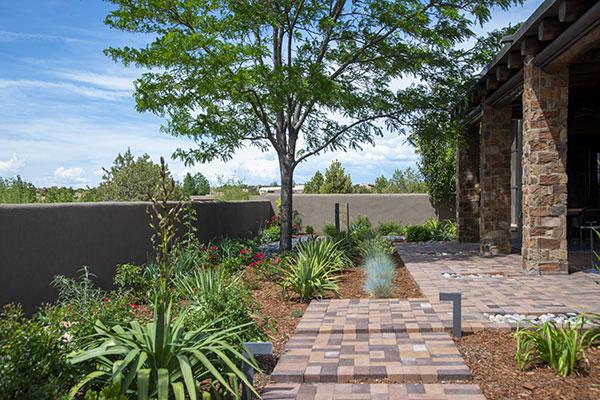 Garden Patio with brick walkways, rocks, plants, trees and lighting