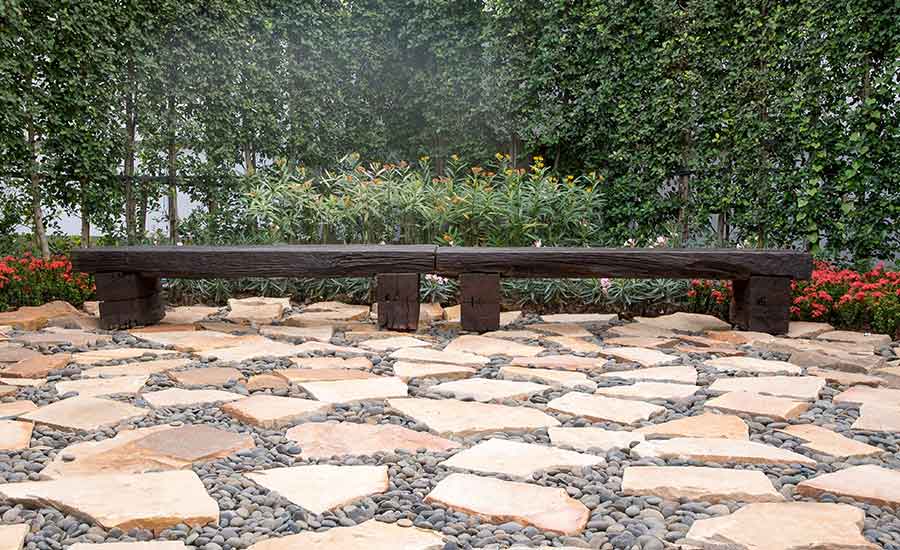 A flagstone patio with wooden benches​