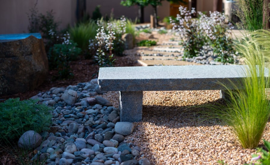 A bench and beautiful plants in a Santa Fe backyard​