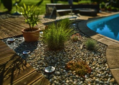 An image of a pool and a stone path